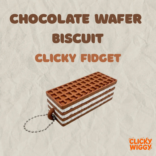 A chocolate wafer biscuit-shaped 3D-printed fidget clicker with a metal ball chain, displayed on a textured beige background. The product features a realistic layered wafer design and is labeled with “CHOCOLATE WAFER BISCUIT CLICKY FIDGET” alongside the Clicky Wiggy logo.